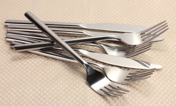 Forks and knives on a beige tablecloth - Φωτογραφία, εικόνα