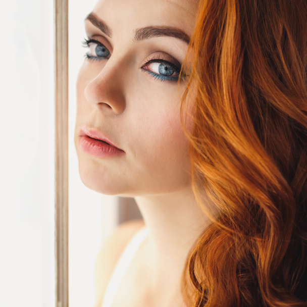 Closeup portrait of redhead young woman in gorgeous lingerie in luxury interior - Фото, зображення
