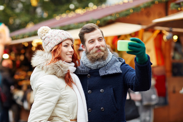couple taking selfie with smartphone in old town - Foto, Imagem