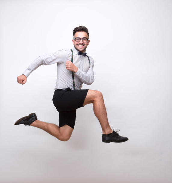 Hipster man jumping in photo studio - Foto, afbeelding