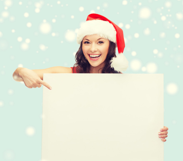 woman in santa hat with white board - 写真・画像