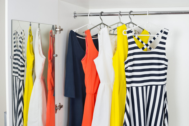 series of bright modern fashion women dresses on hangers - Zdjęcie, obraz