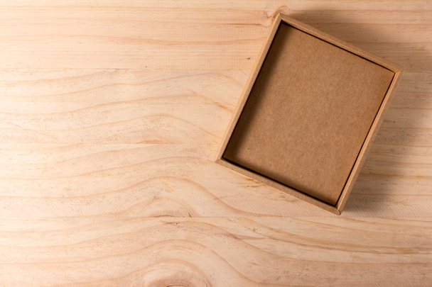 Opened cardboard box on wooden background - Fotó, kép