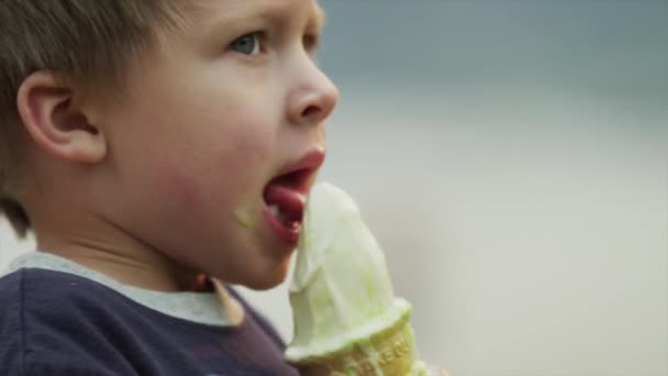 boy licking ice cream cone - Video