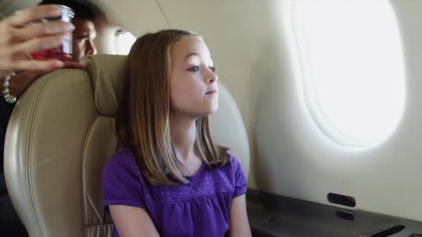Girl drinking juice in airplane - Video