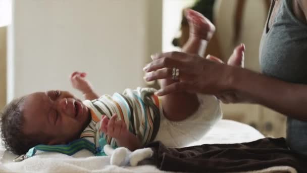 Woman dressing up baby boy - Filmati, video