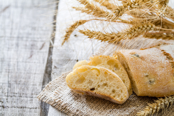 Ciabatta and wheat on   wooden background - 写真・画像