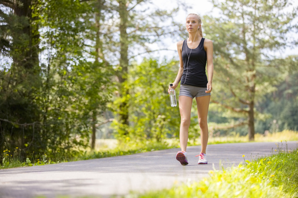Woman walking outdoor in the forest as workout - Photo, Image