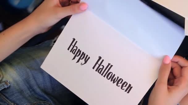 Girl Opens The Card. Happy Halloween Written in The card. - Felvétel, videó