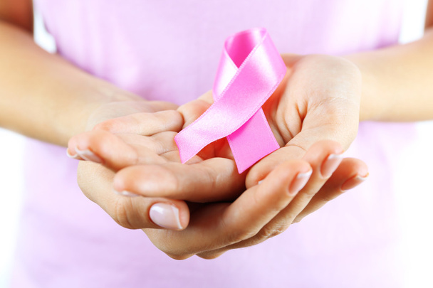 Pink ribbon in woman's hands - Zdjęcie, obraz