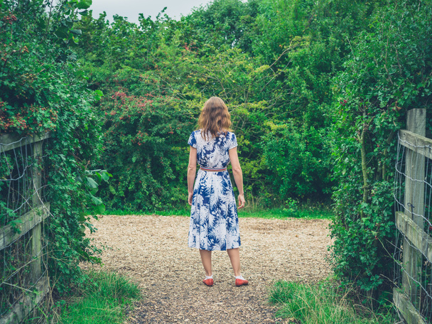 Young woman walking in the countryside - Фото, зображення