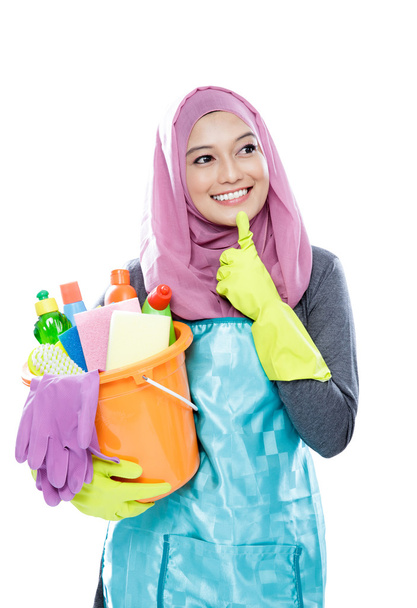 young woman wearing hijab thinking while holding a bucket full o - Photo, Image