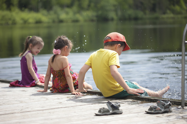 Трое веселых детей играют на озере
 - Фото, изображение