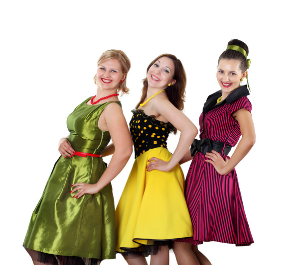 Three young woman in bright colour dresses - Фото, изображение