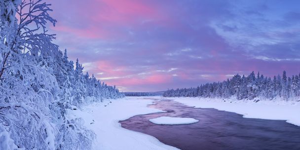 Sunrise over river rapids in a winter landscape, Finnish Lapland - Photo, image