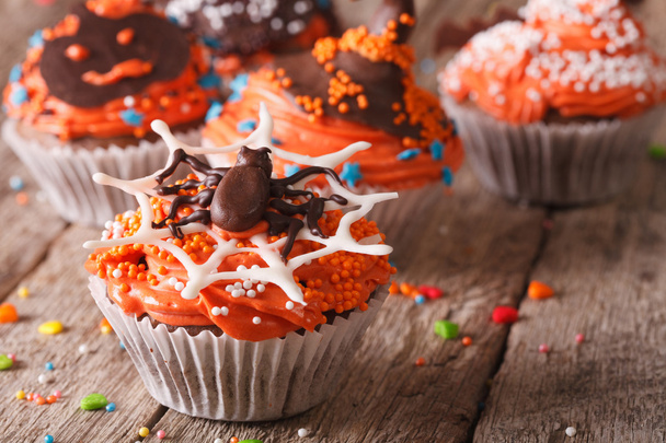 Funny colorful Halloween cupcakes on a table close-up. - Zdjęcie, obraz
