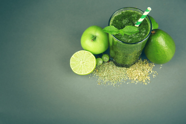 Green healthy juice with fruits and spices on gray background - Fotografie, Obrázek