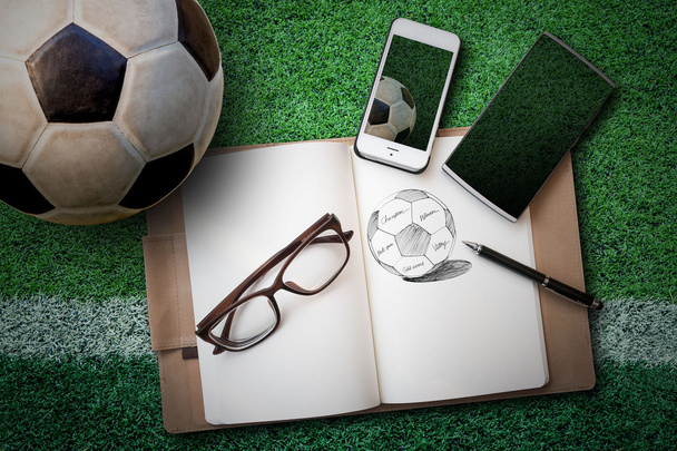 soccer ball, sketch book, glasses, smartphone on green artificia - Fotografie, Obrázek