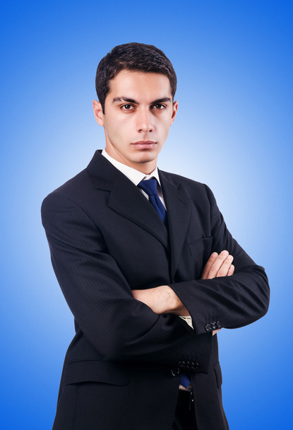 Handsome businessman isolated on blue - Photo, Image