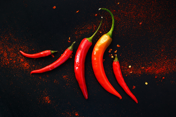 Chili peppers on a black background - Photo, Image