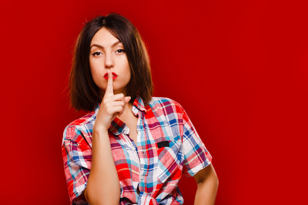 Woman posing with finger in front of her face - Photo, Image