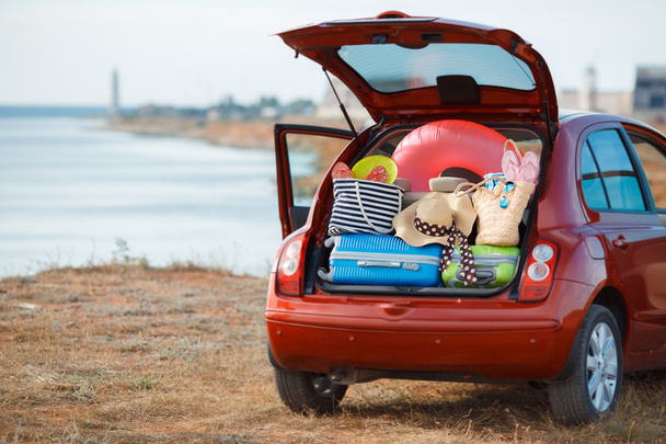 Suitcases and bags in trunk of car ready to depart for holidays - Photo, image