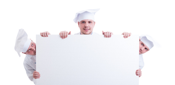 Three cooks or chefs holding a blank cardboard - Zdjęcie, obraz