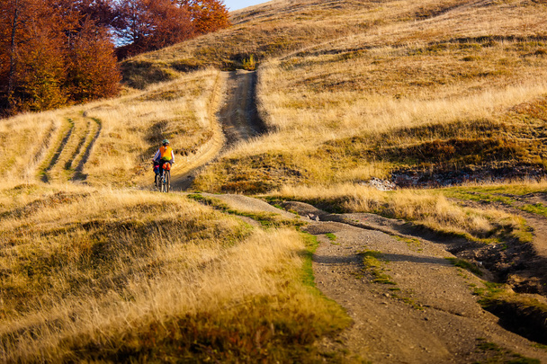 Biker riding in autumn mountains - Zdjęcie, obraz
