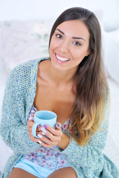 Beautiful woman with a cup of morning coffee - 写真・画像