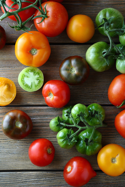 red, green and yellow tomatoes on boards - 写真・画像