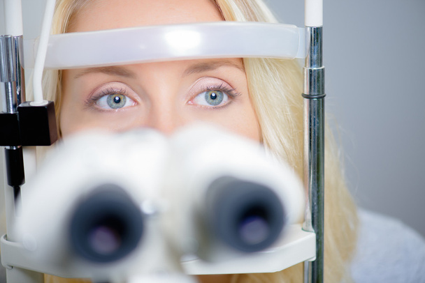 Blond woman having an eye exam - Фото, зображення