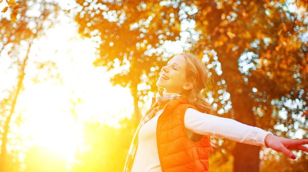 happy girl enjoying life and freedom in autumn on nature - 写真・画像