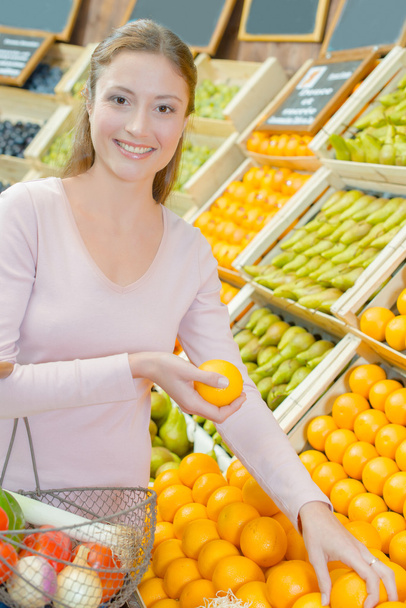Woman stood by the fruit stand - Fotografie, Obrázek