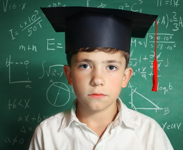 boy in graduation cap   blackboard background - Photo, Image