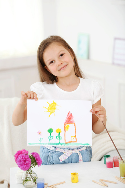 Cute little girl  with picture at home - Fotografie, Obrázek