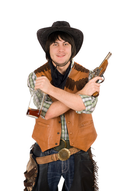 bir şişe ve silah ile gülümseyen kovboy - Fotoğraf, Görsel