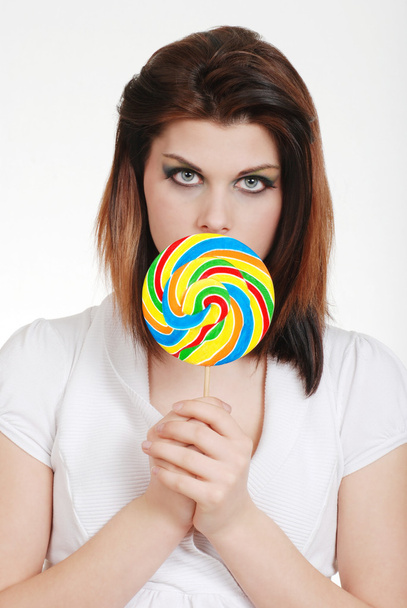 Young woman with colorful lollipop - 写真・画像