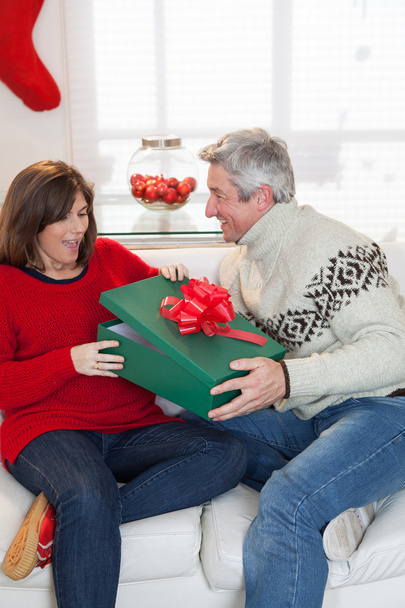Woman opening the gift that gives her husband - Photo, image