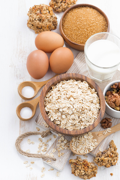 oat flakes and ingredients on a white wooden table, top view - Photo, image