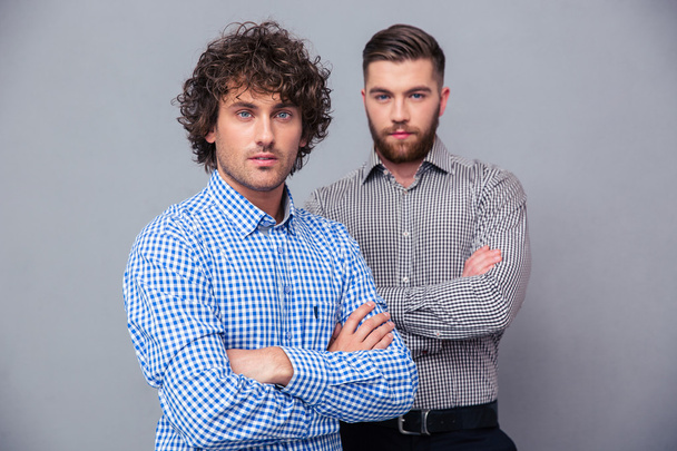 Casual businessmen standing with arms folded - Fotoğraf, Görsel