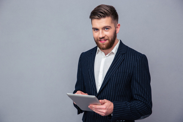 Happy businessman using tablet computer - Photo, image