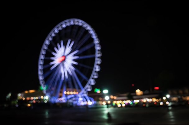 Blurred light of ferris wheel ,Blurred defocused night lights - Photo, Image