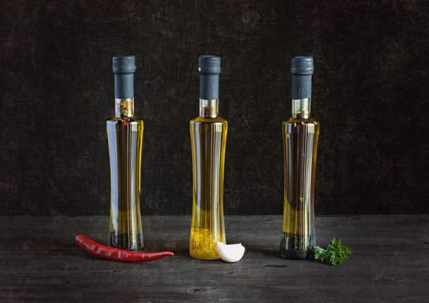 olive oil and spices on a dark background - Фото, изображение
