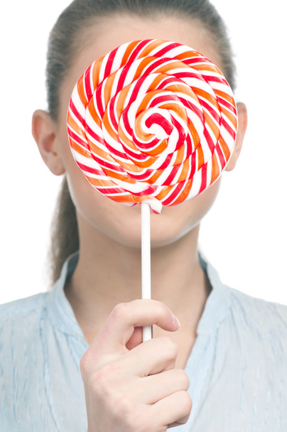 Pretty young woman with lollipop. Isolated - Zdjęcie, obraz