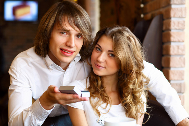 Young couple with engagement ring in a restaurant - Fotoğraf, Görsel