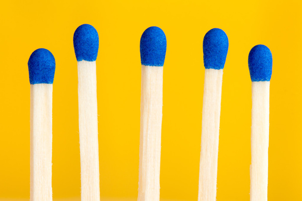 Five matchsticks on yellow background - Foto, immagini