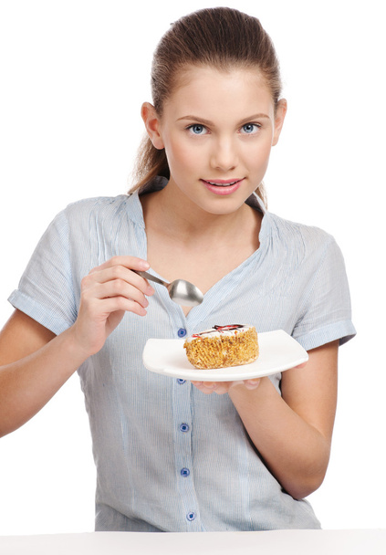 Pretty young woman eating cake. Isolated - Foto, Imagen