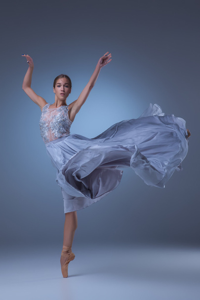 The beautiful ballerina dancing in blue long dress - Фото, зображення