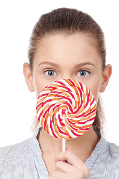 Pretty young woman with lollipop. Isolated - Zdjęcie, obraz