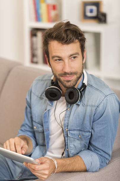 young man listenig music with digital tablet at home - Φωτογραφία, εικόνα